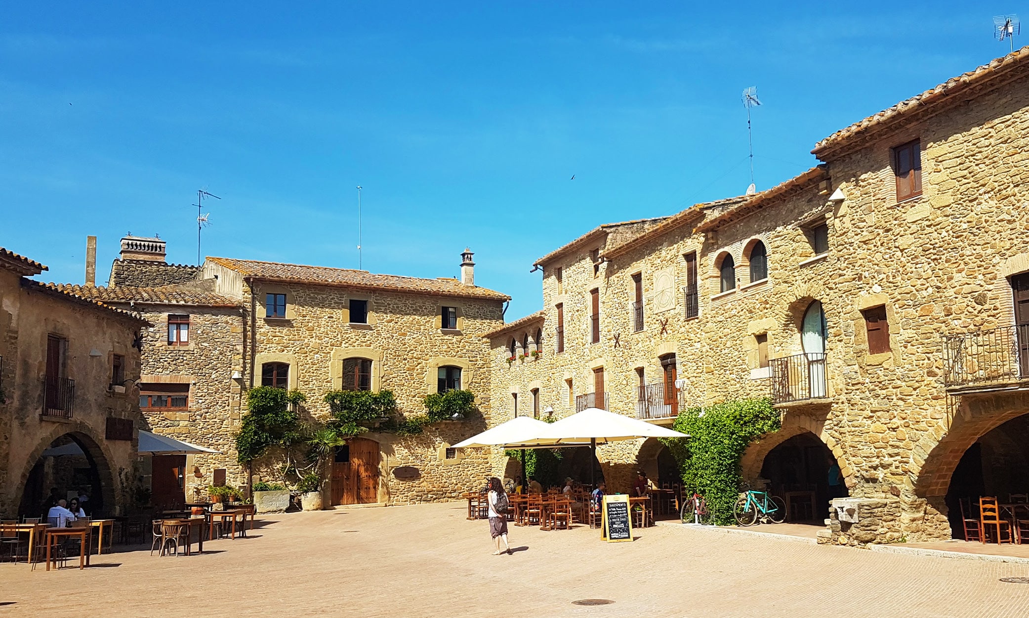 The main square in Monells with its characteristic arches