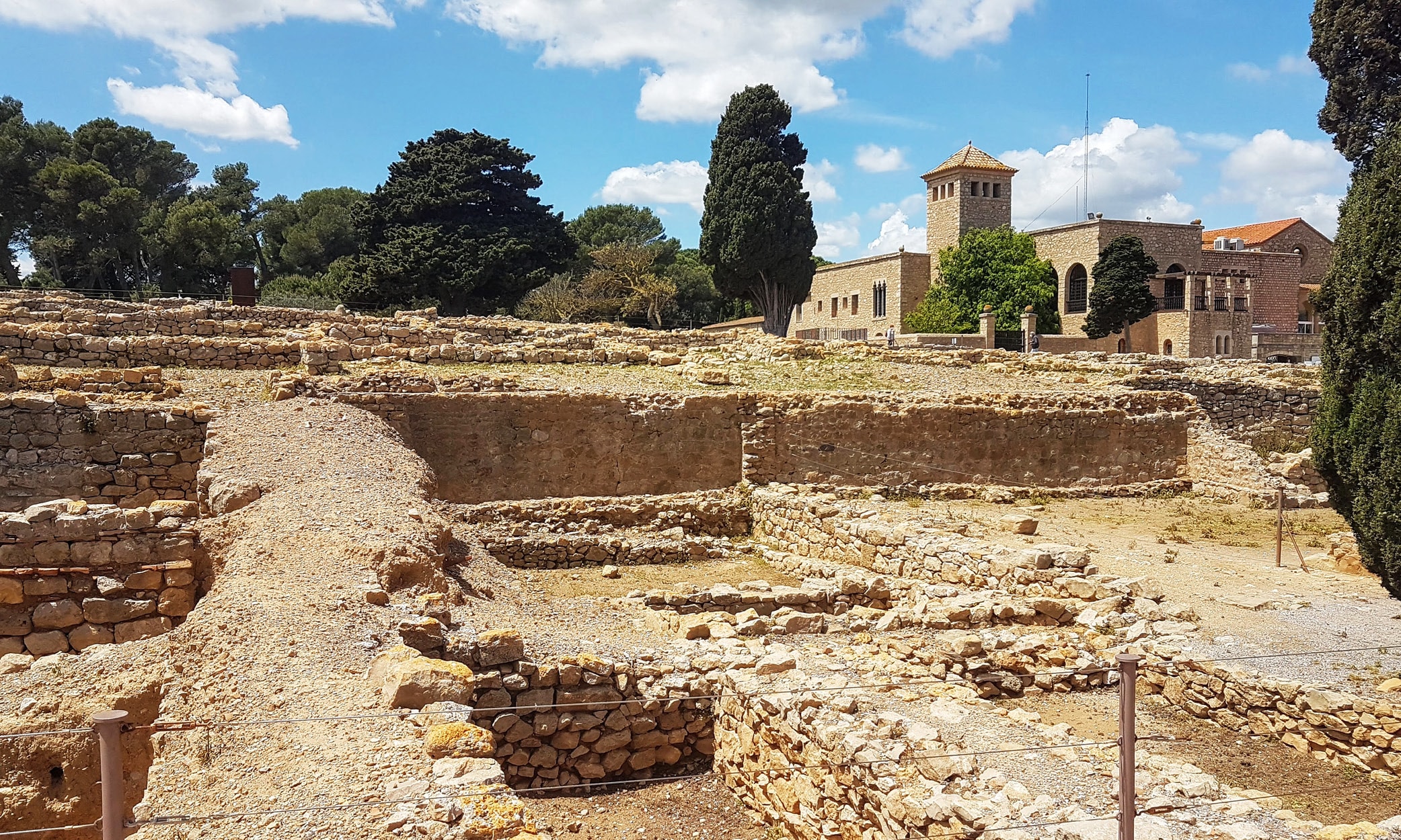 njoy costa brava ancient empuries museum and ruins of the old greek part of the settlement The ruins of the old ancient Greek part at Empúries, with the museum in the background near L’Escala, Costa Brava, Catalunya, Spain