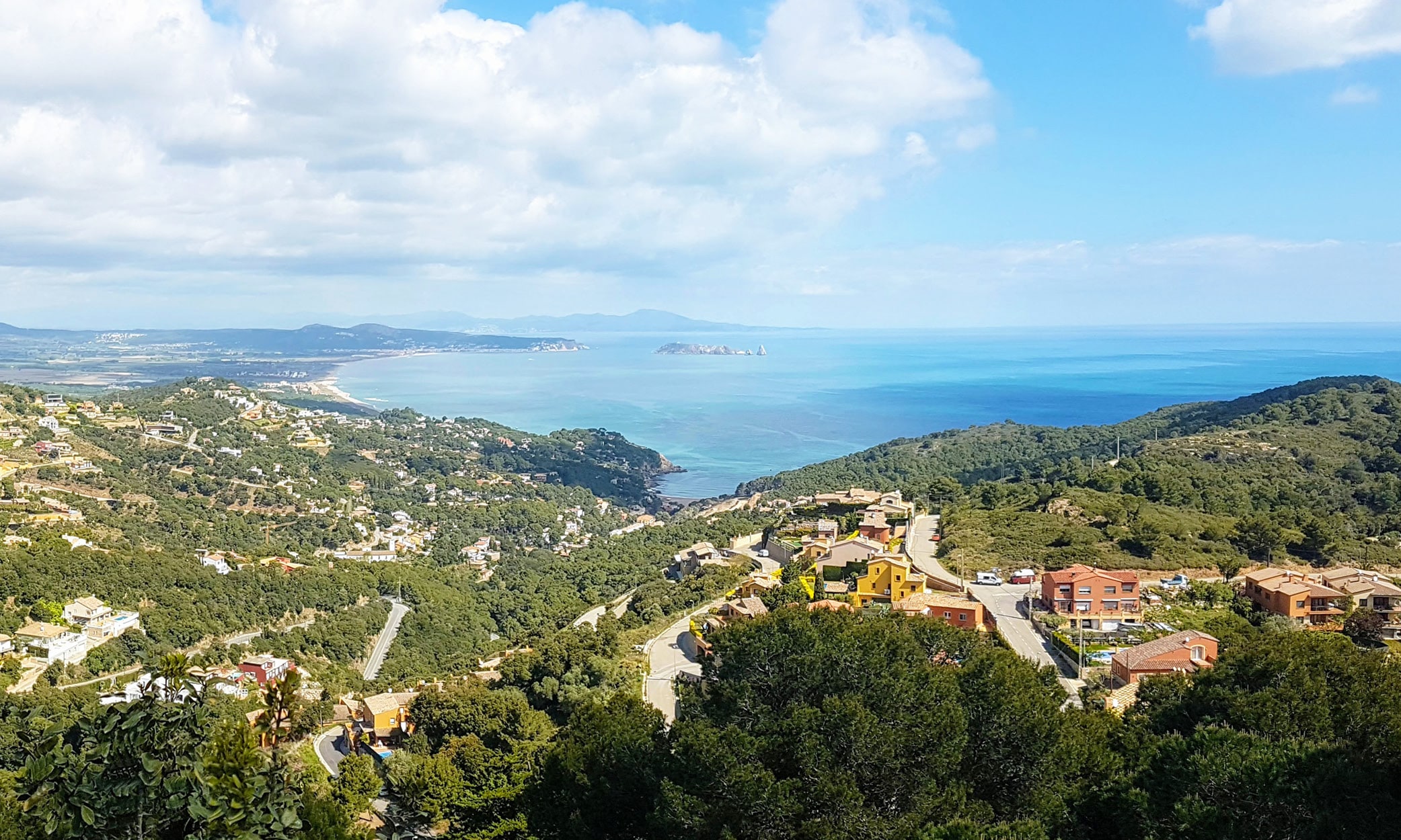 Panoramic coastal view from Begur Castle overlooking La Costa Brava with the Medes Islands in the distance.