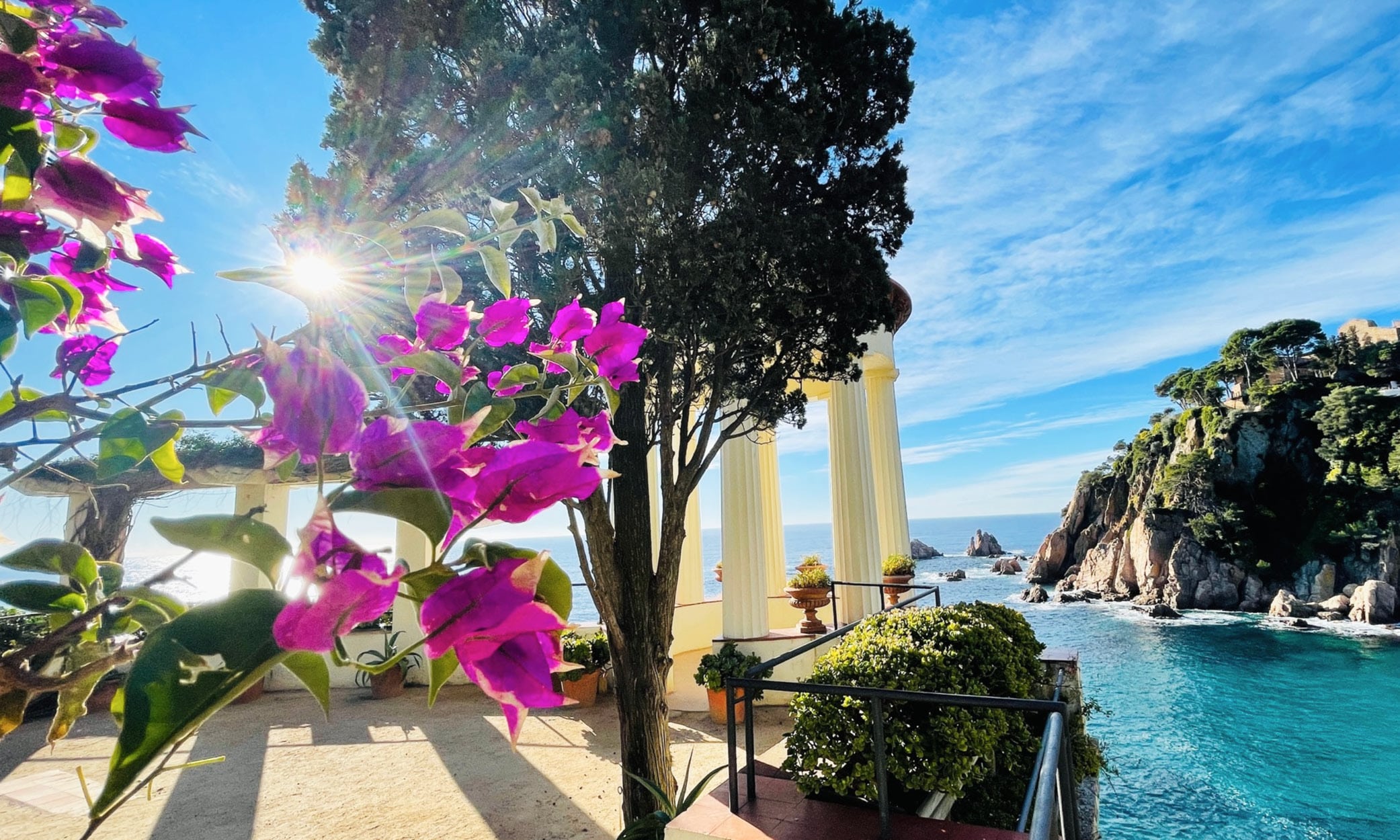 View from Marimurta Botanic Gardens in Blanes with Mediterranean Sea and coastal cliffs in the background.
